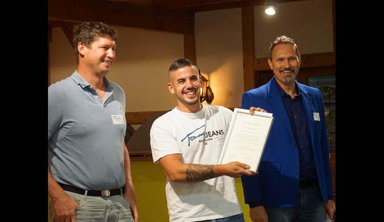 Michael Jeitzinger von der Prüfungskommission und Angelo Gallo, Kommissionspräsident, überreichten Nicola De Paola den Eidg. Fachausweis Rohrnetzmonteur.