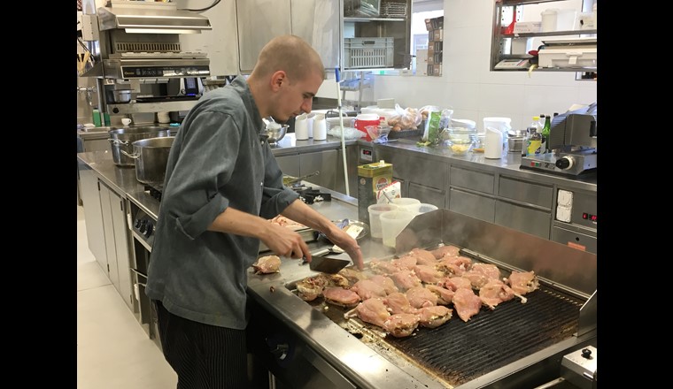 Der Koch beim Anbraten der edlen Fleischspezialitäten auf dem Gasgrill