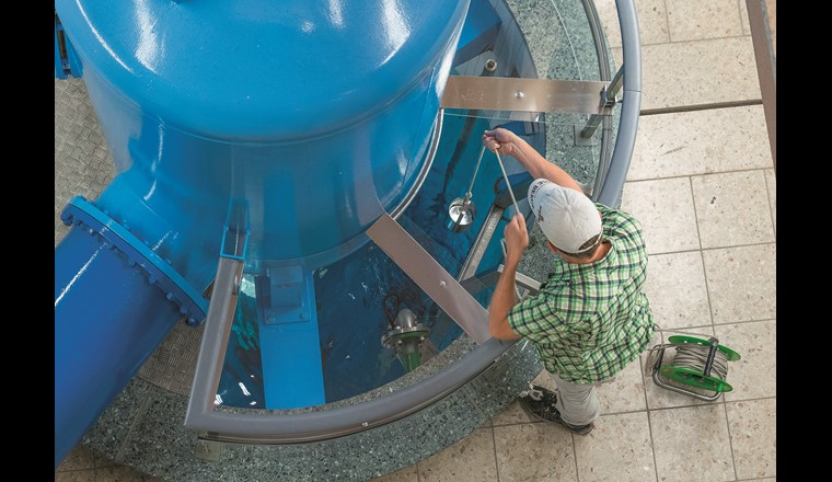 Prélèvement d'échantillons dans un puits d'eau souterraine par un employé de l'Office des eaux et des déchets (AWA) du canton de Berne (©Markus Zeh, AWA Berne)